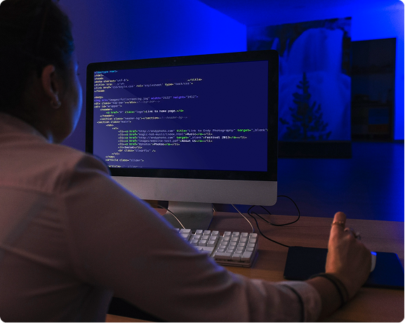 Laptop displaying a modern website dashboard and responsive code editor next to mobile views.