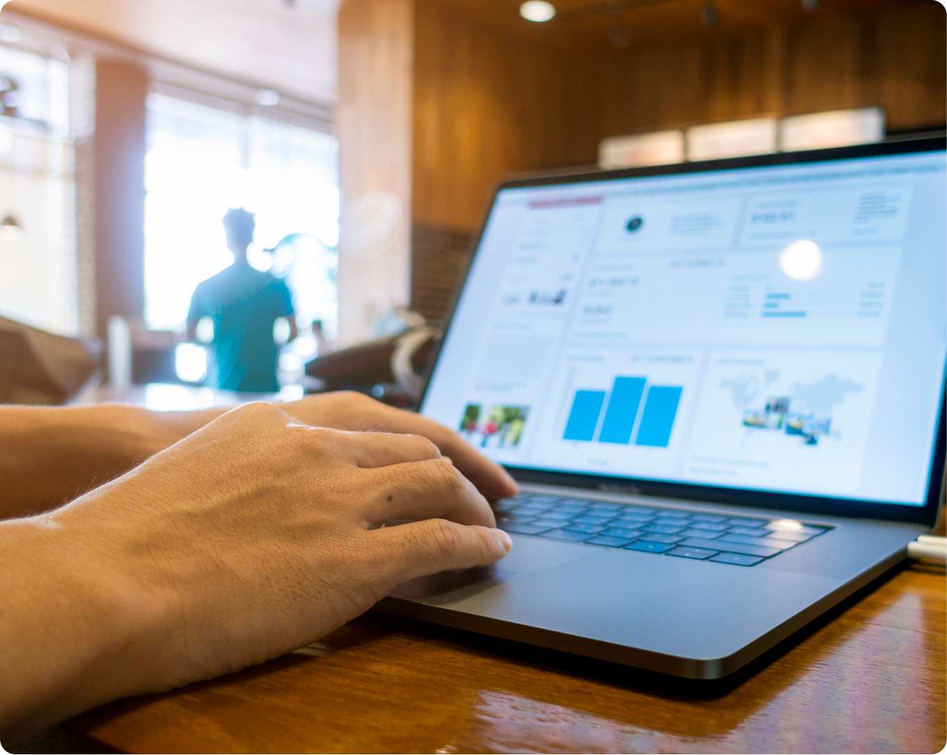   Person with a laptop showing a search results and traffic dashboard.